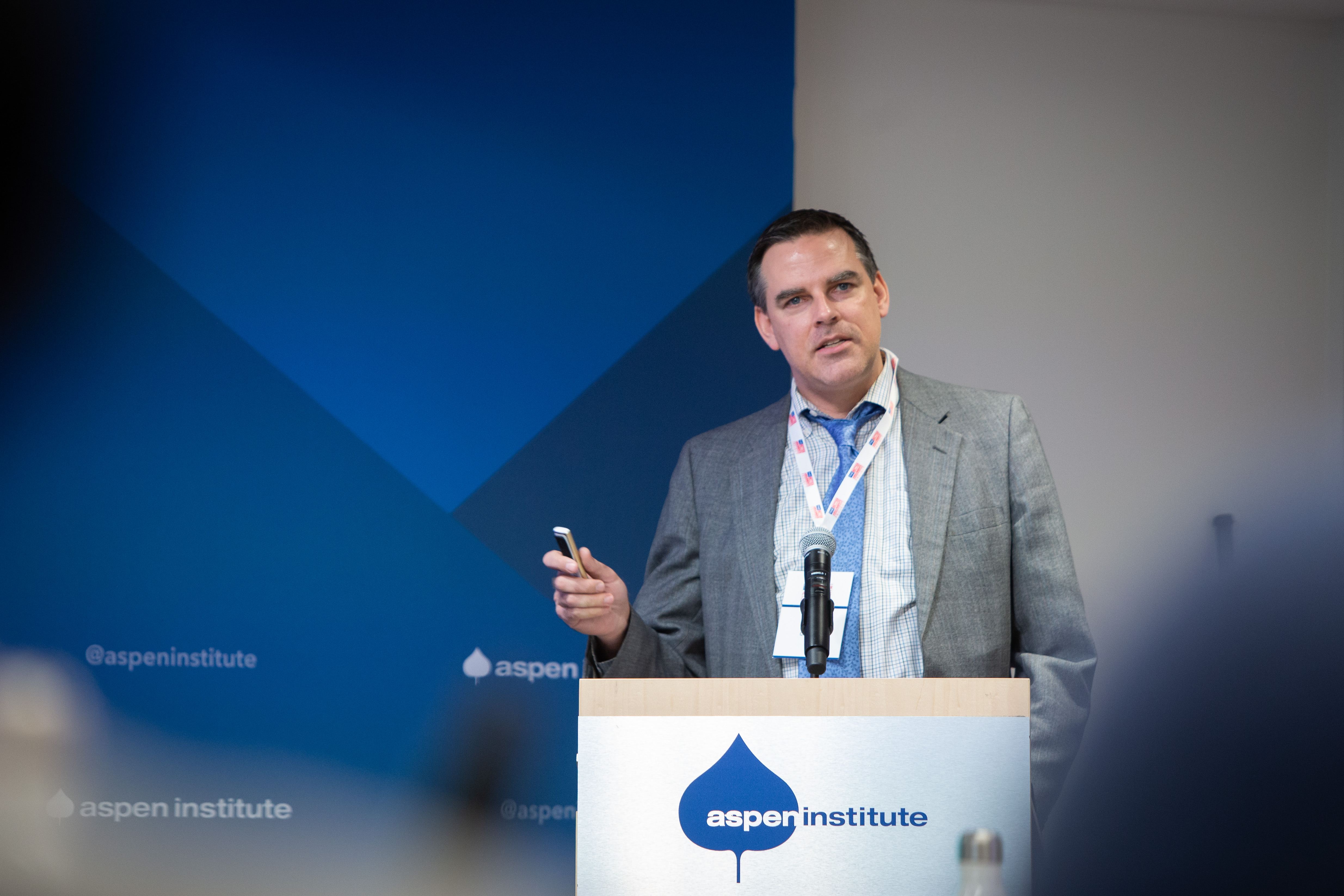 Director of Strategic Relationships Jerad Morey frowning while presenting at Aspen Institute