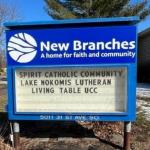 The sign in front of New Branches, which lists its three member congregations.